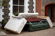 A pile of discarded furniture in a street.