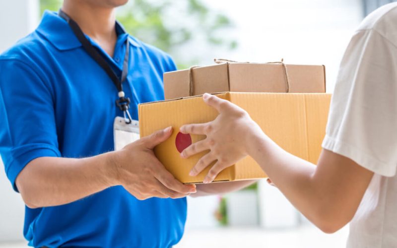 woman-hand-accepting-delivery-boxes-from-deliveryman-1-1024x683